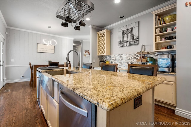 kitchen featuring dark wood-style floors, crown molding, cream cabinetry, and stainless steel dishwasher