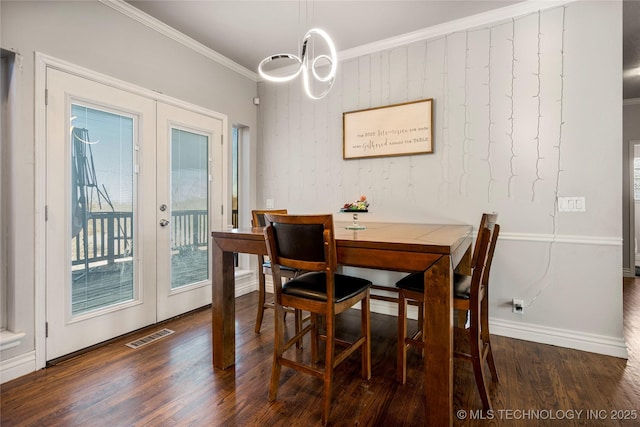 dining room featuring dark wood-style floors, french doors, visible vents, and crown molding