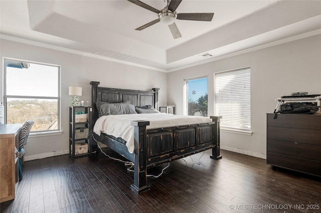 bedroom featuring a raised ceiling, visible vents, baseboards, and dark wood-style flooring