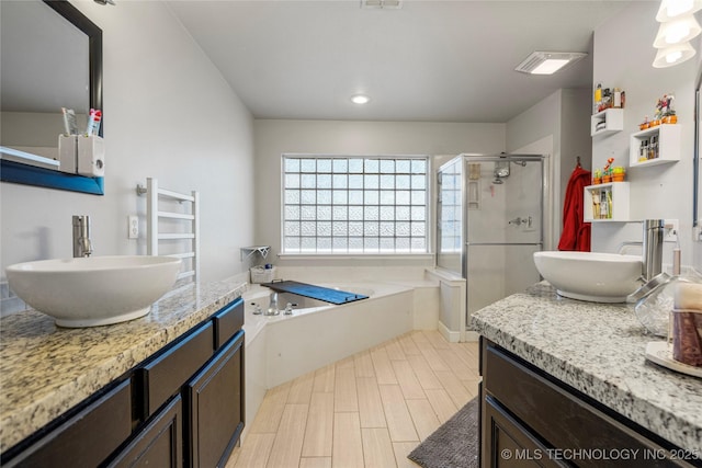 full bathroom with wood finish floors, visible vents, a stall shower, vanity, and a bath