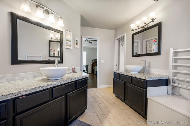 full bathroom with ceiling fan, wood finish floors, two vanities, and a sink