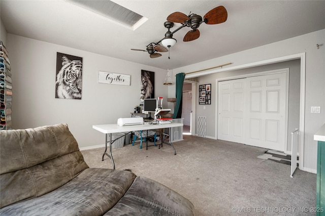 carpeted office featuring ceiling fan and baseboards