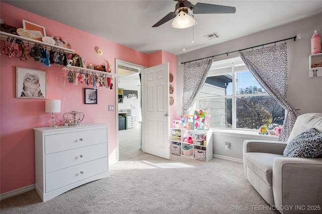 living area with carpet floors, visible vents, ceiling fan, and baseboards