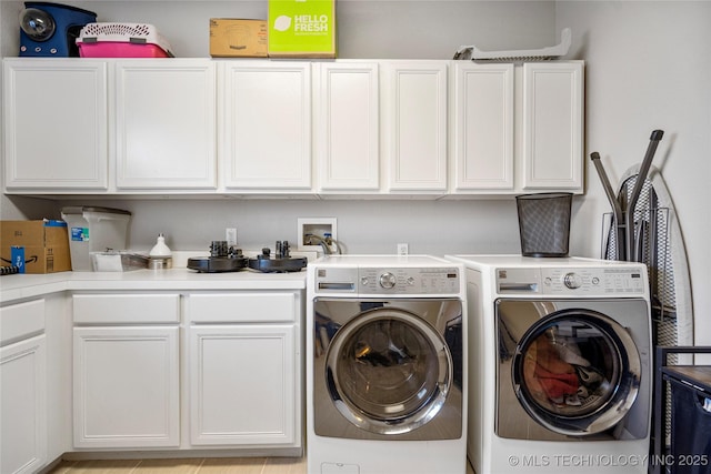 laundry area with cabinet space and separate washer and dryer