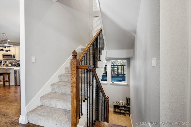 stairs with baseboards and wood finished floors