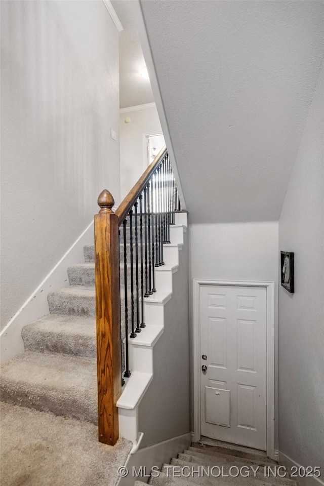 staircase featuring baseboards