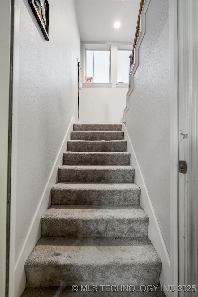 staircase with a textured wall