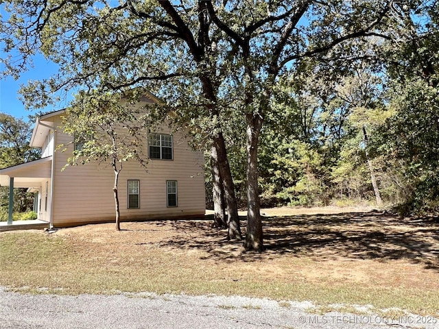 view of side of home with a carport