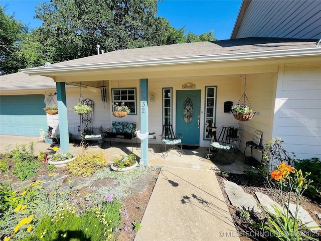 property entrance with an attached garage and covered porch