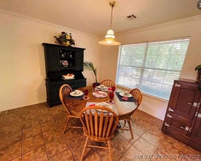 6532 Canadian Dr, Kingston, OK 73439 - dining space with tile patterned floors, visible vents, and ornamental molding