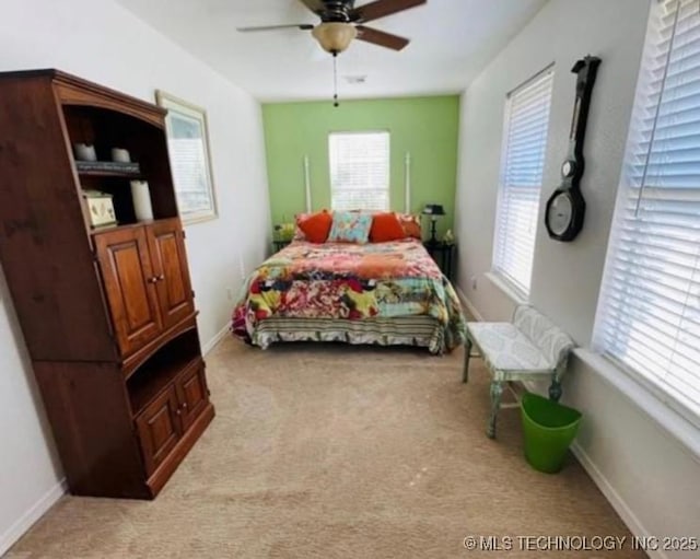 bedroom featuring baseboards, light carpet, and ceiling fan