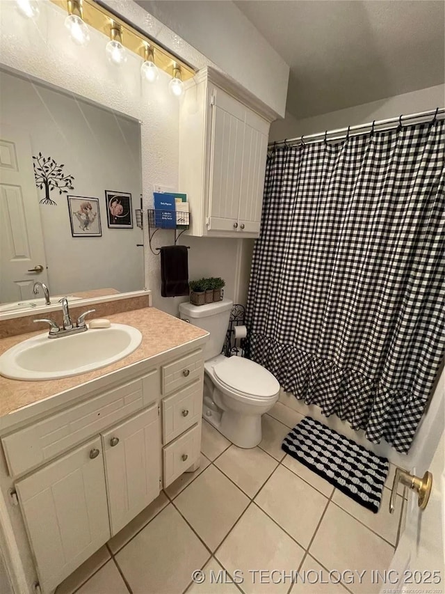 full bath with curtained shower, toilet, vanity, and tile patterned flooring