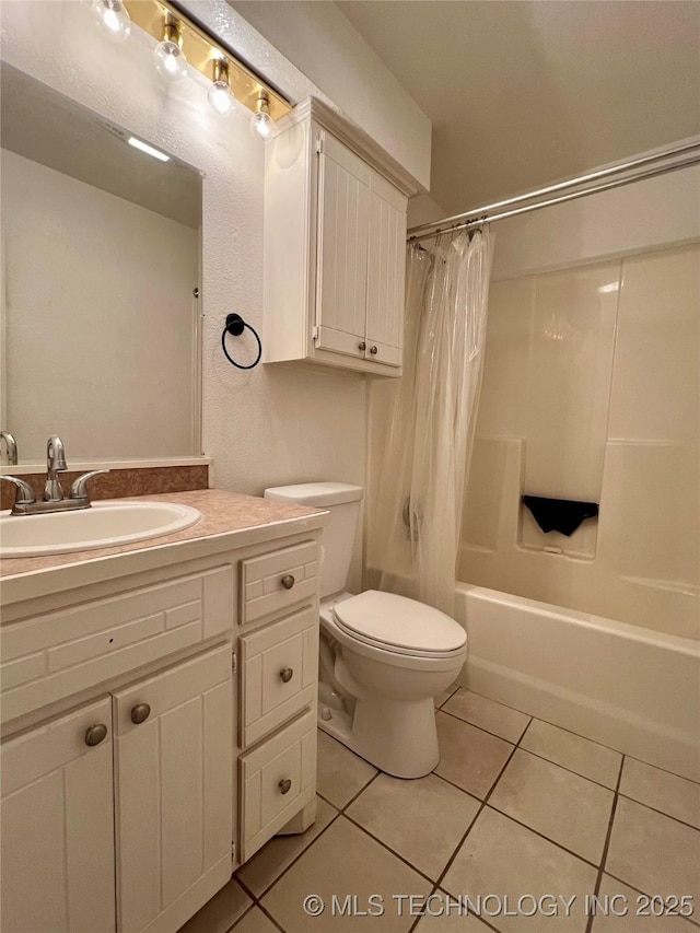 bathroom with vanity, tile patterned floors, shower / bath combination with curtain, and toilet