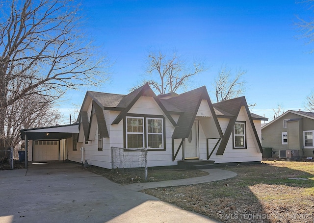 view of front of house with an attached garage, central AC unit, and concrete driveway