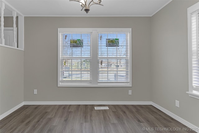 unfurnished dining area with dark wood-style floors, ornamental molding, visible vents, and baseboards