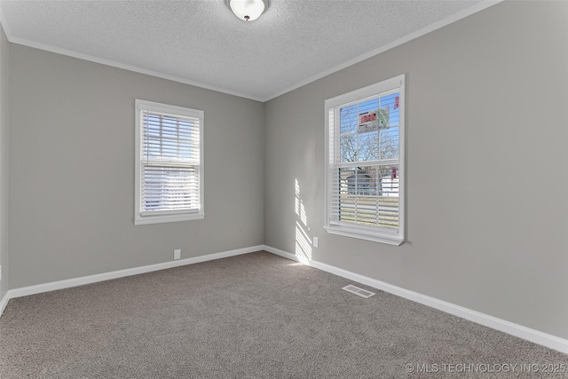 empty room with baseboards, carpet, and crown molding