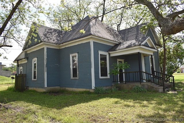 view of property exterior with a yard and roof with shingles