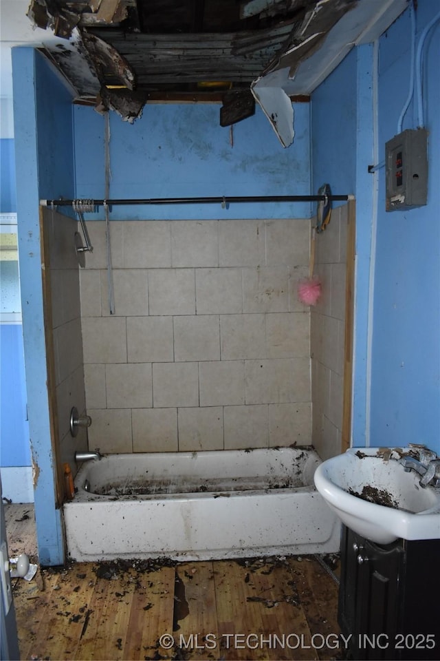 full bath featuring electric panel, vanity, shower / bathtub combination, and wood finished floors