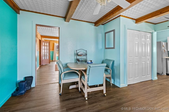 dining area with wood finished floors, baseboards, beam ceiling, ornamental molding, and ceiling fan