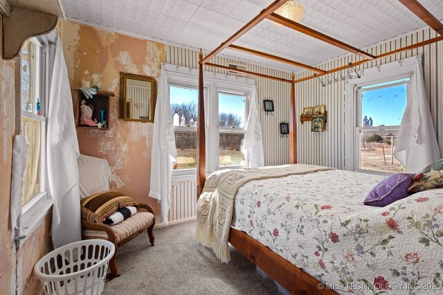 bedroom featuring carpet and wallpapered walls