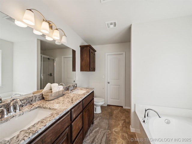 full bath with visible vents, a sink, a shower stall, and a garden tub