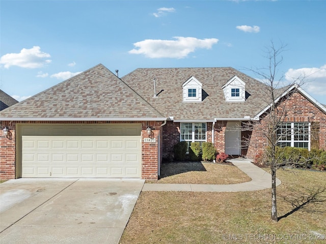 view of front of house featuring a garage, concrete driveway, brick siding, and roof with shingles