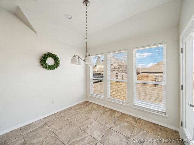 unfurnished dining area featuring an inviting chandelier, vaulted ceiling, baseboards, and light tile patterned floors