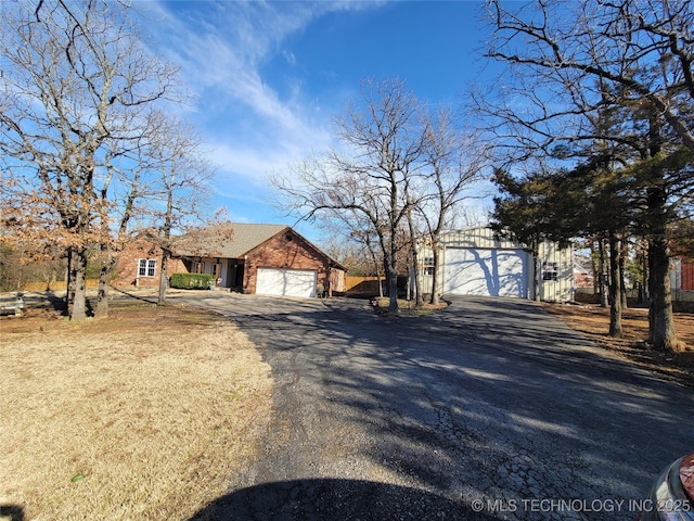 view of front of house with a garage, a gate, and driveway