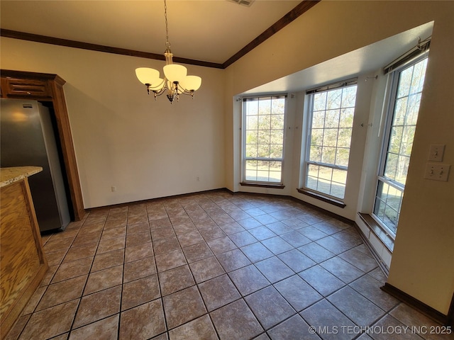 unfurnished dining area with a healthy amount of sunlight, an inviting chandelier, crown molding, and tile patterned floors