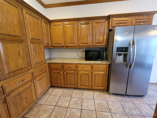 kitchen featuring brown cabinets, black microwave, and stainless steel refrigerator with ice dispenser