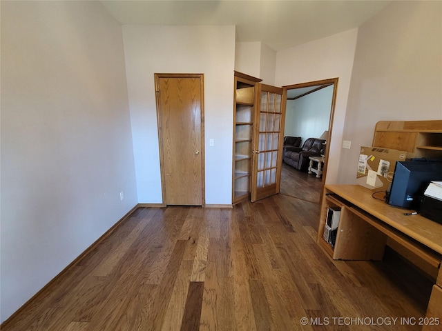 bedroom with french doors, dark wood finished floors, and baseboards