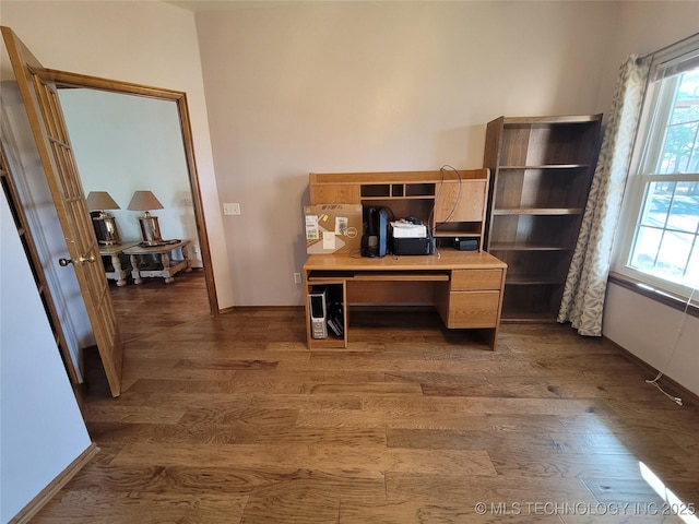 home office with plenty of natural light, baseboards, and dark wood-style flooring