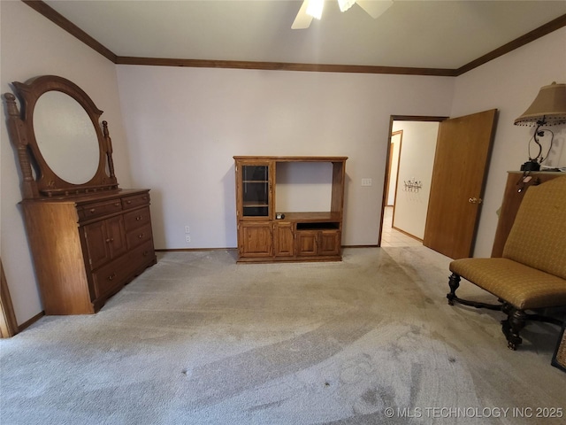 interior space with ornamental molding, light colored carpet, baseboards, and a ceiling fan