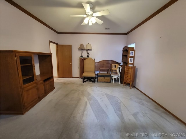 sitting room with ornamental molding, light colored carpet, a ceiling fan, and baseboards