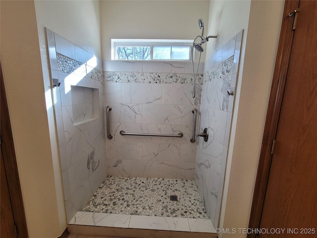 bathroom with a tile shower