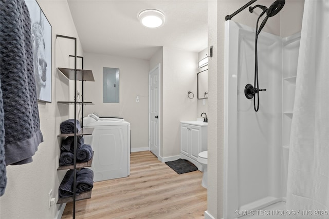 bathroom with washer / dryer, curtained shower, electric panel, and wood finished floors