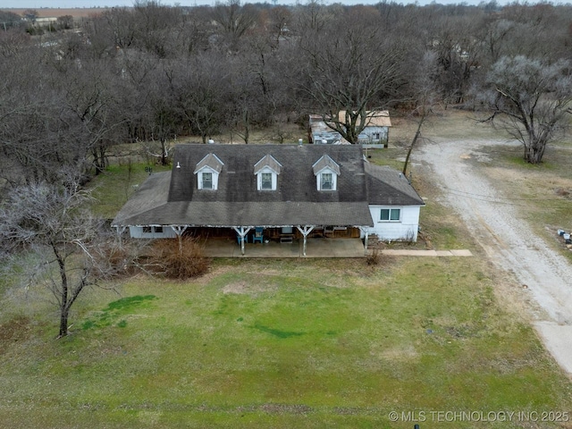 birds eye view of property with a wooded view