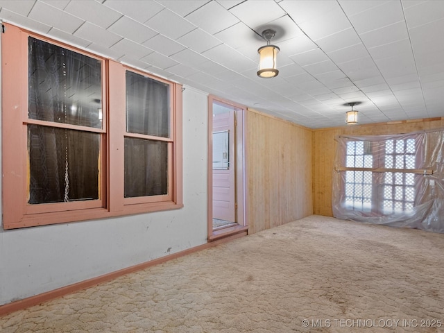 carpeted empty room with baseboards