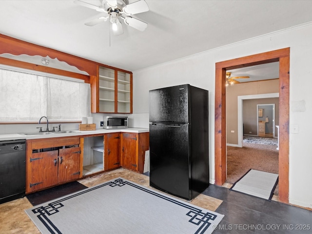 kitchen with black appliances, a sink, light countertops, and a ceiling fan