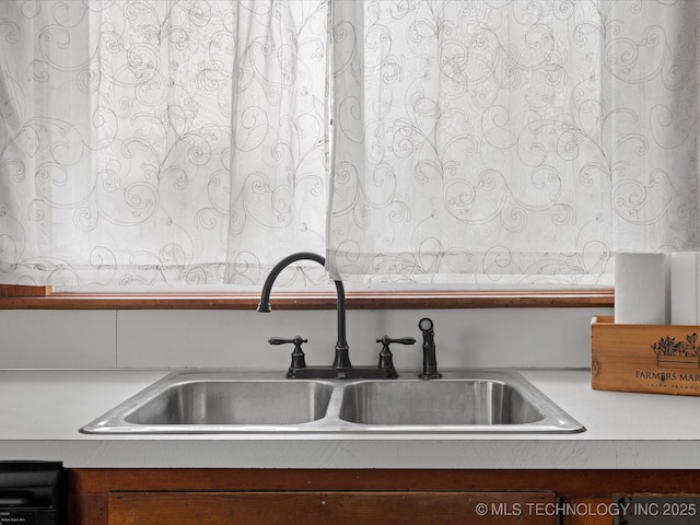 interior details featuring light countertops and a sink