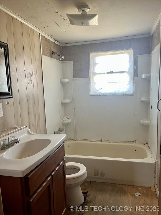 bathroom featuring washtub / shower combination, toilet, wood finished floors, and vanity