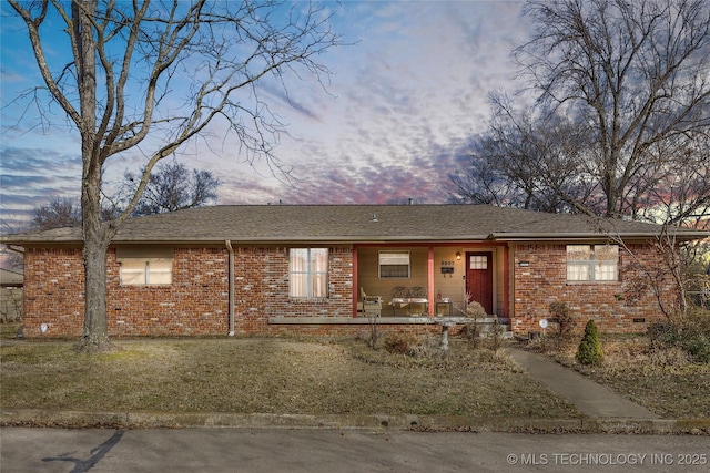 ranch-style house featuring crawl space, covered porch, and brick siding