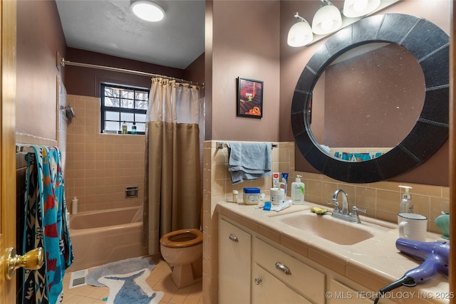 bathroom with tasteful backsplash, toilet, shower / bath combo, vanity, and tile patterned floors