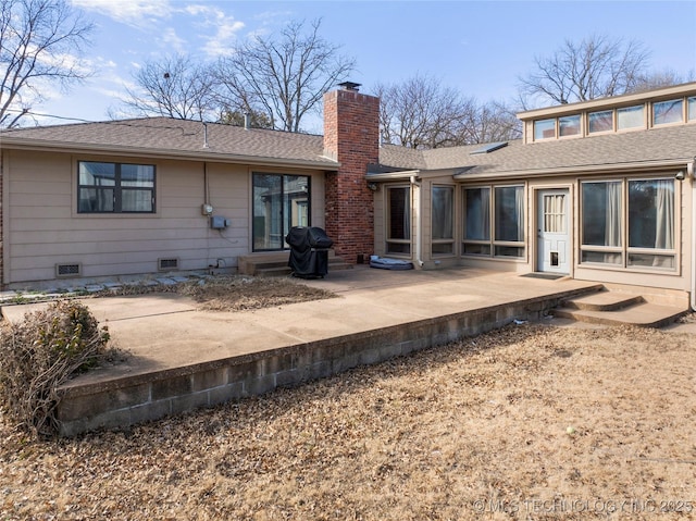 rear view of house featuring a chimney, roof with shingles, crawl space, and a patio area