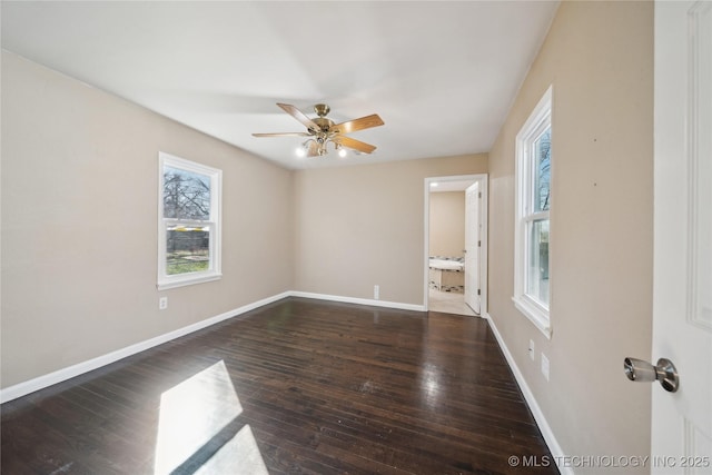 spare room featuring a ceiling fan, baseboards, and hardwood / wood-style floors