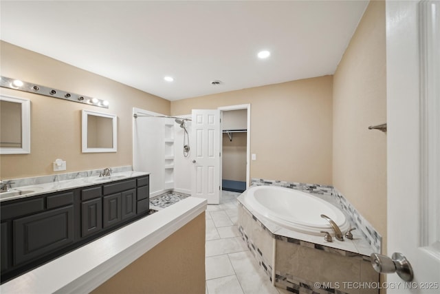 full bathroom with a bath, a shower stall, tile patterned floors, and a sink