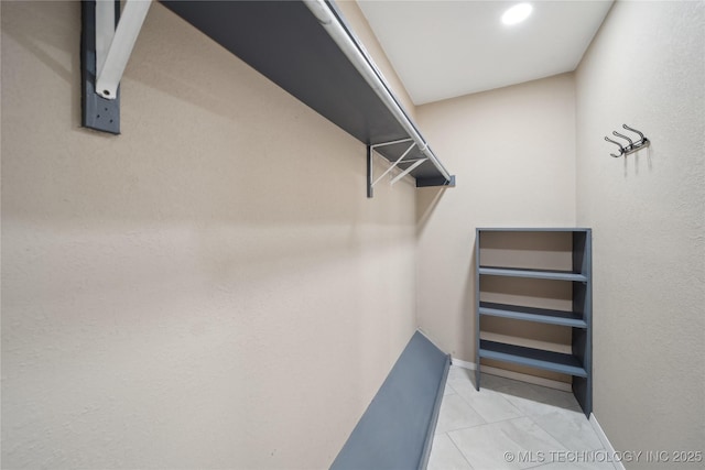 spacious closet featuring light tile patterned floors