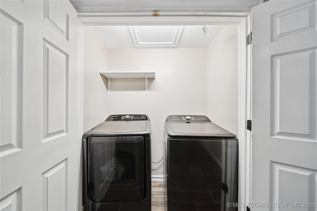 washroom featuring laundry area, washer and dryer, and wood finished floors