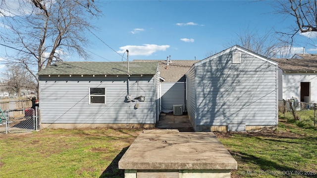 view of outbuilding with central AC and fence