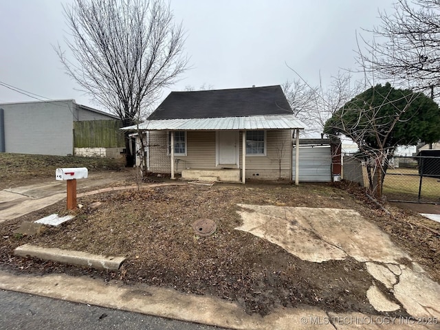 view of front of home with metal roof, a porch, and fence